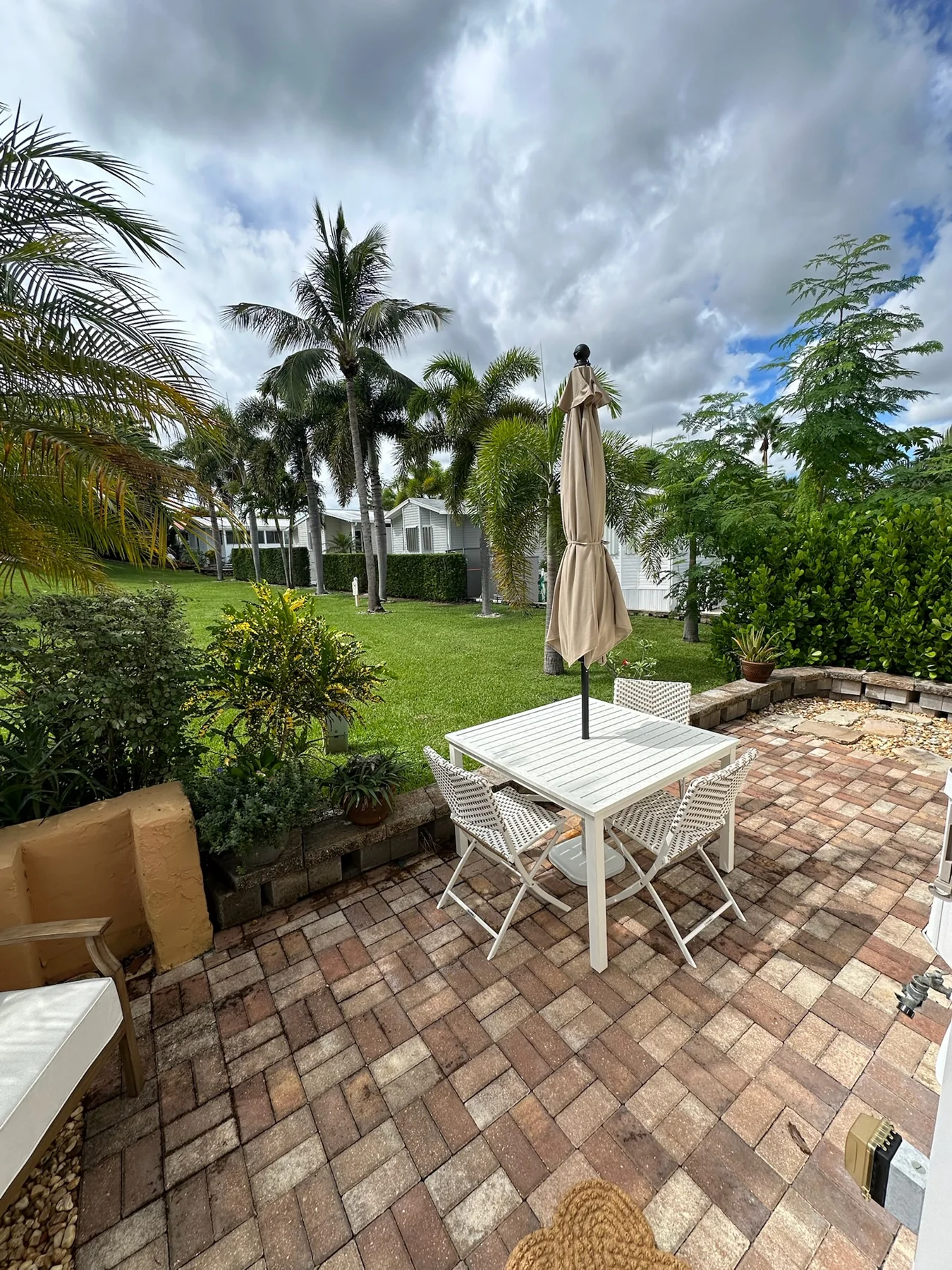 The home’s patio with outdoor seating and tropical greenery